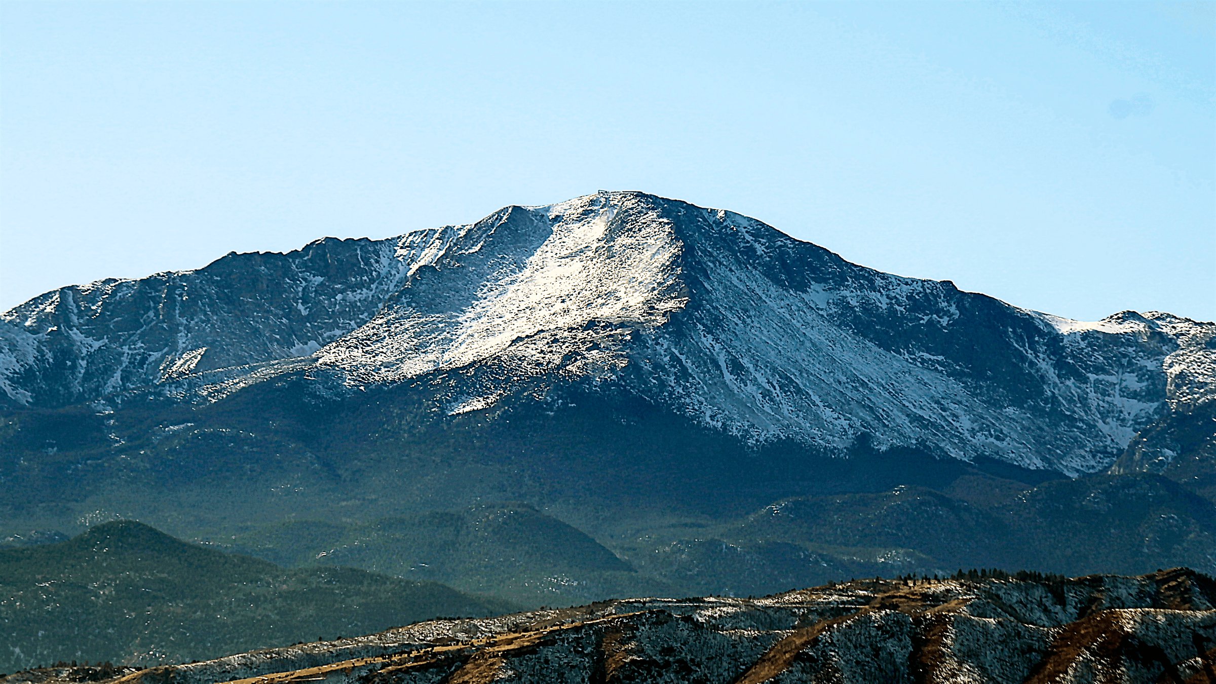 Photograph of Pikes Peak under snow, taken from Colorado Springs