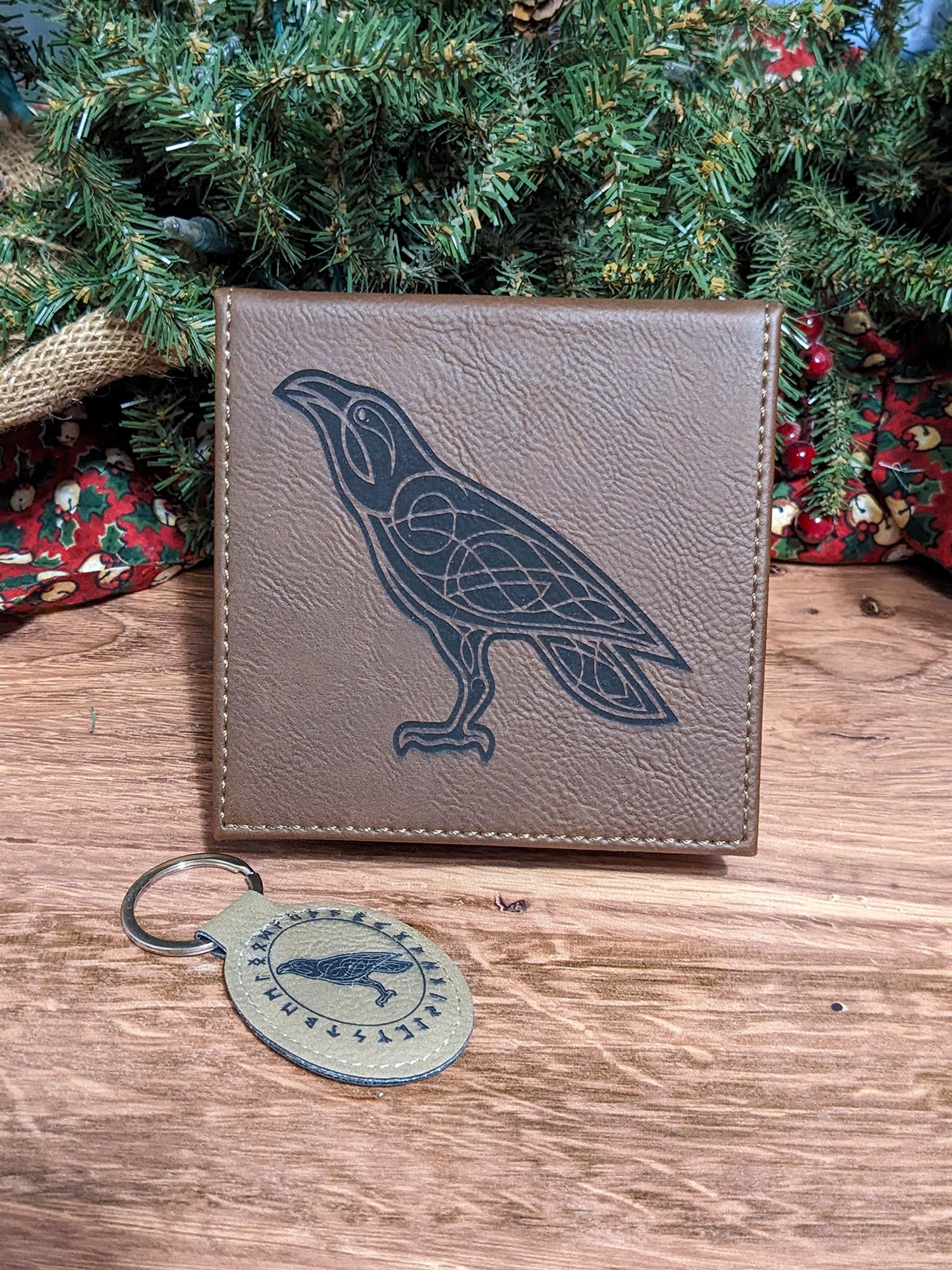 Gray coaster engraved with a Norse-style raven, with a matching key ring